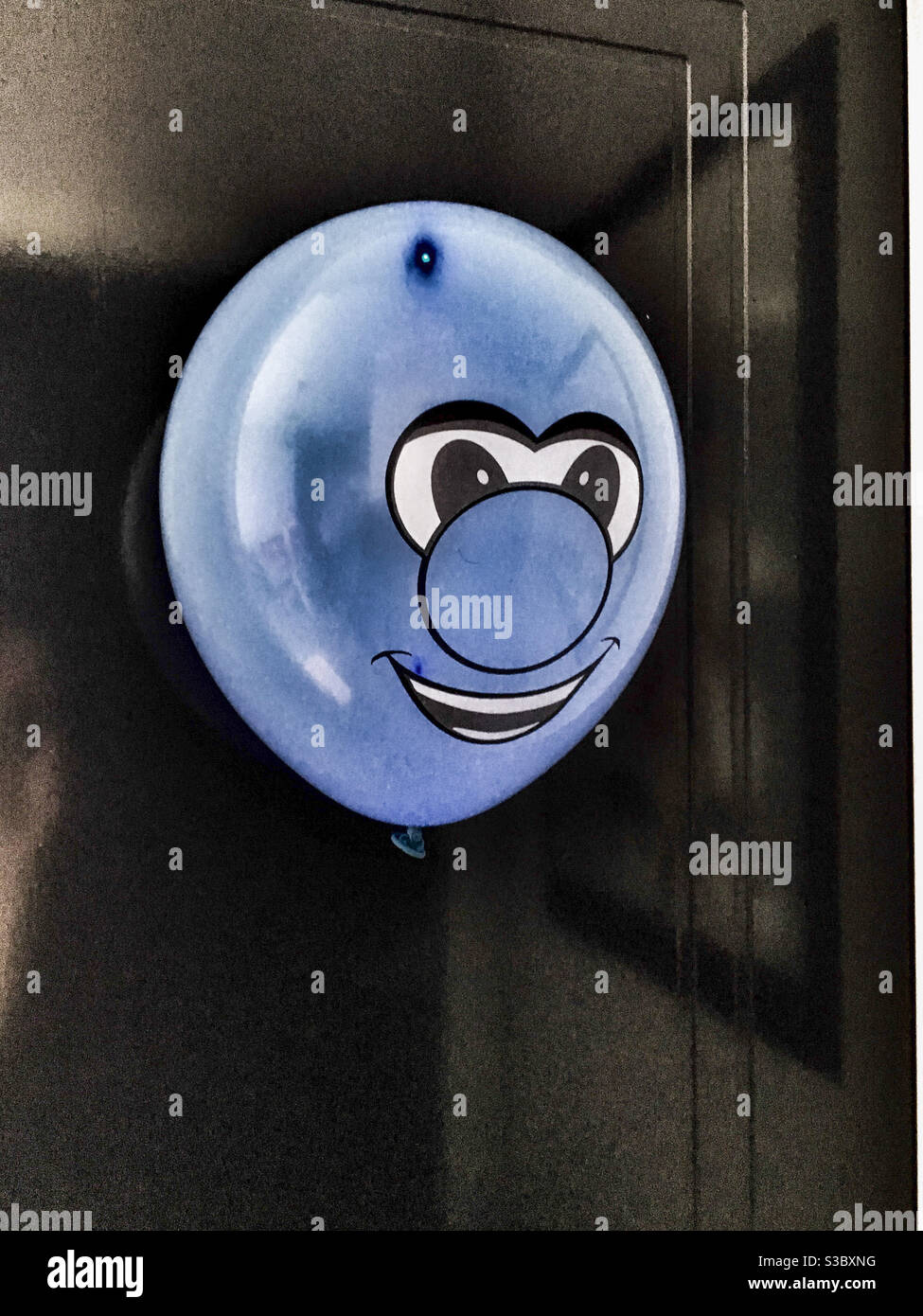 Weird blue smiley face balloon Stock Photo