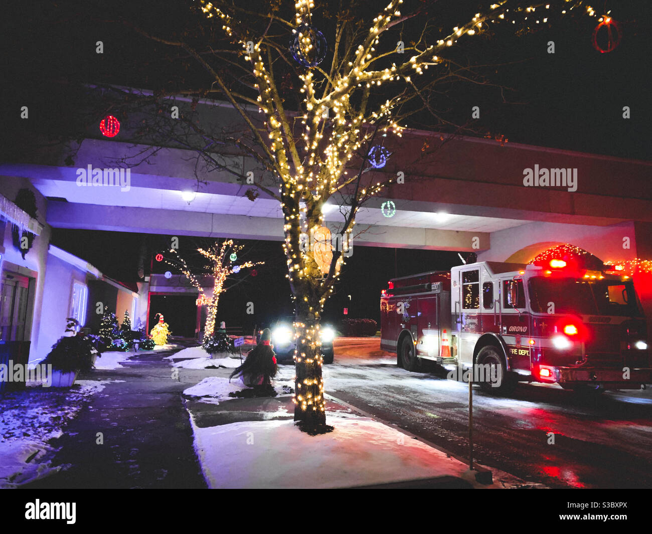 Emergency vehicles in a hotel porte-cochère in December 2020 - drunk people emptied a fire extinguisher in the hallway, evacuating an entire floor. - Smartphone Captured Stock Image