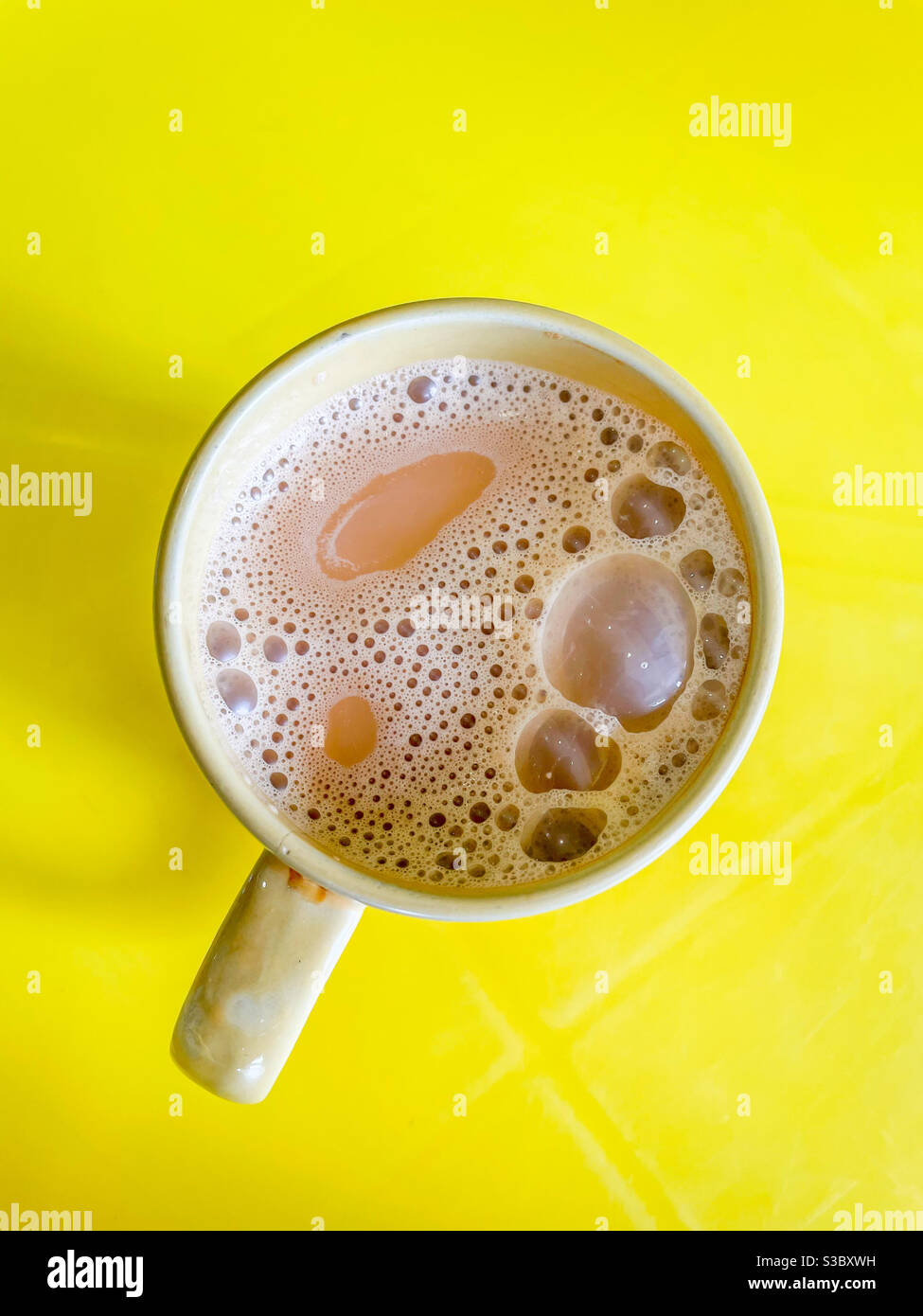 A mug of teh tarik or pulled tea mixed with sweetened condensed milk
