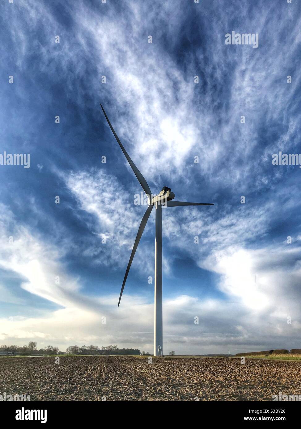 A electricity power generation windmill in a rural countryside environment Stock Photo
