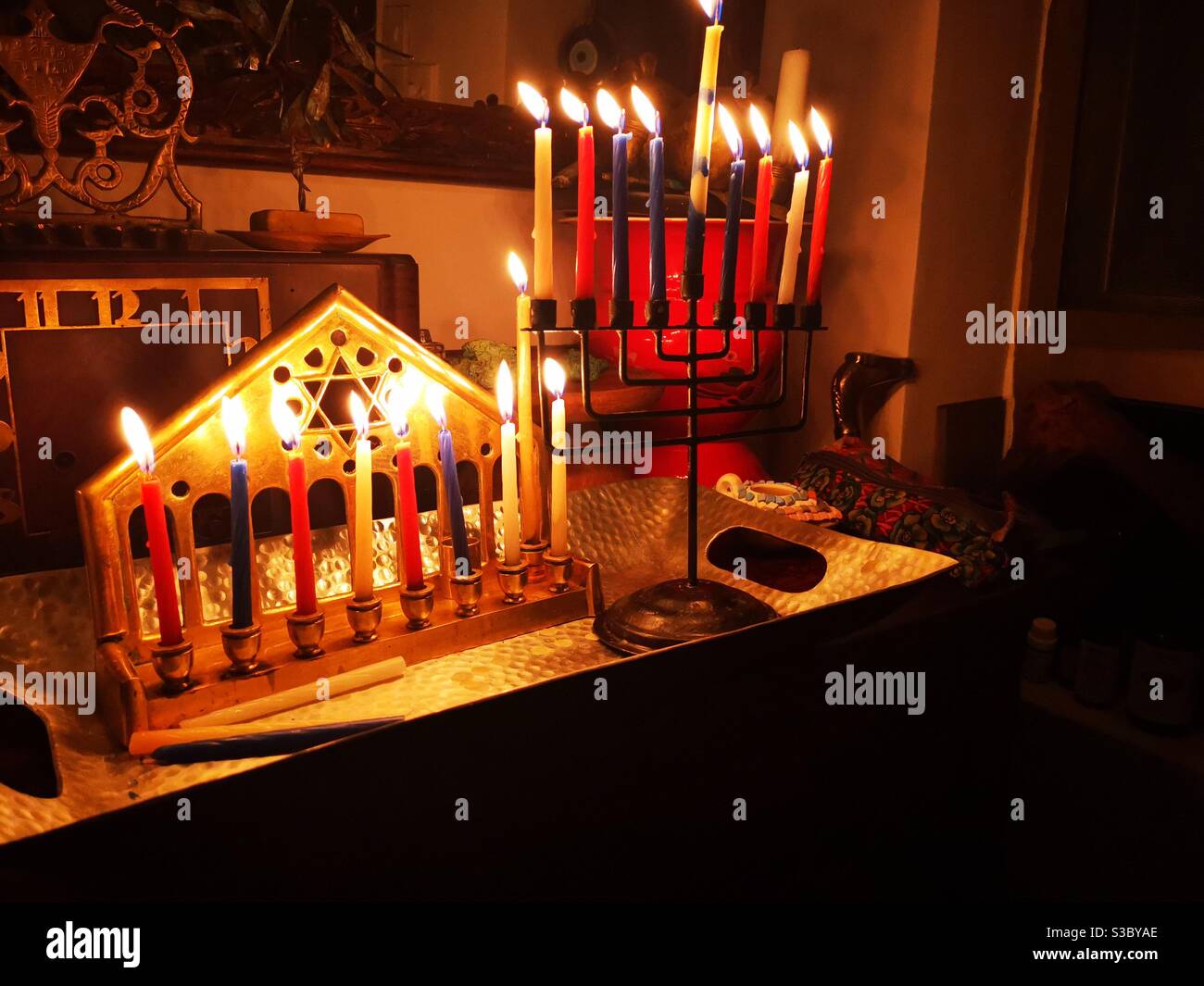 Hannukah candles burning in the menorah. - Smartphone Captured Stock Image