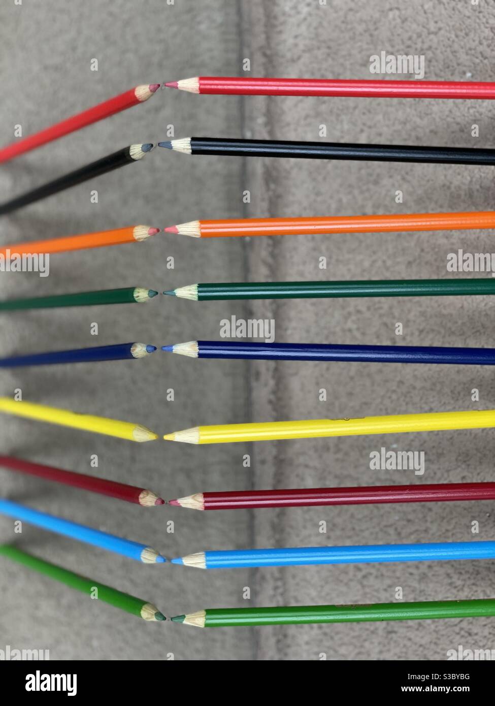 Colorful pencils with reflections on a mirrored surface - Smartphone Captured Stock Image