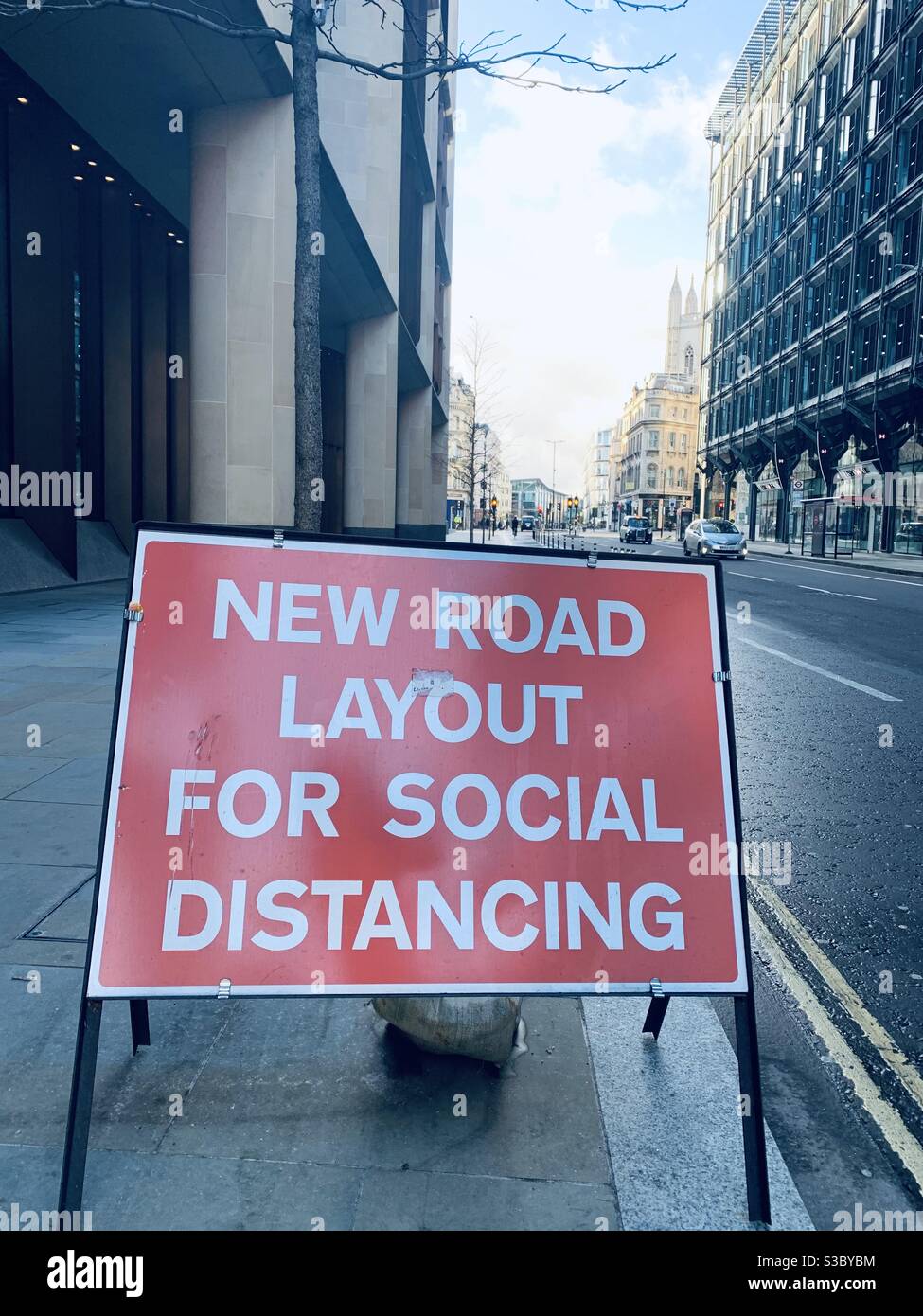 Red square sign new Covid road layout for social distancing Stock Photo