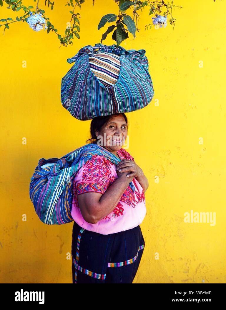Manuela in Antigua with her vintage handwoven Guatemalan textiles for sale Stock Photo