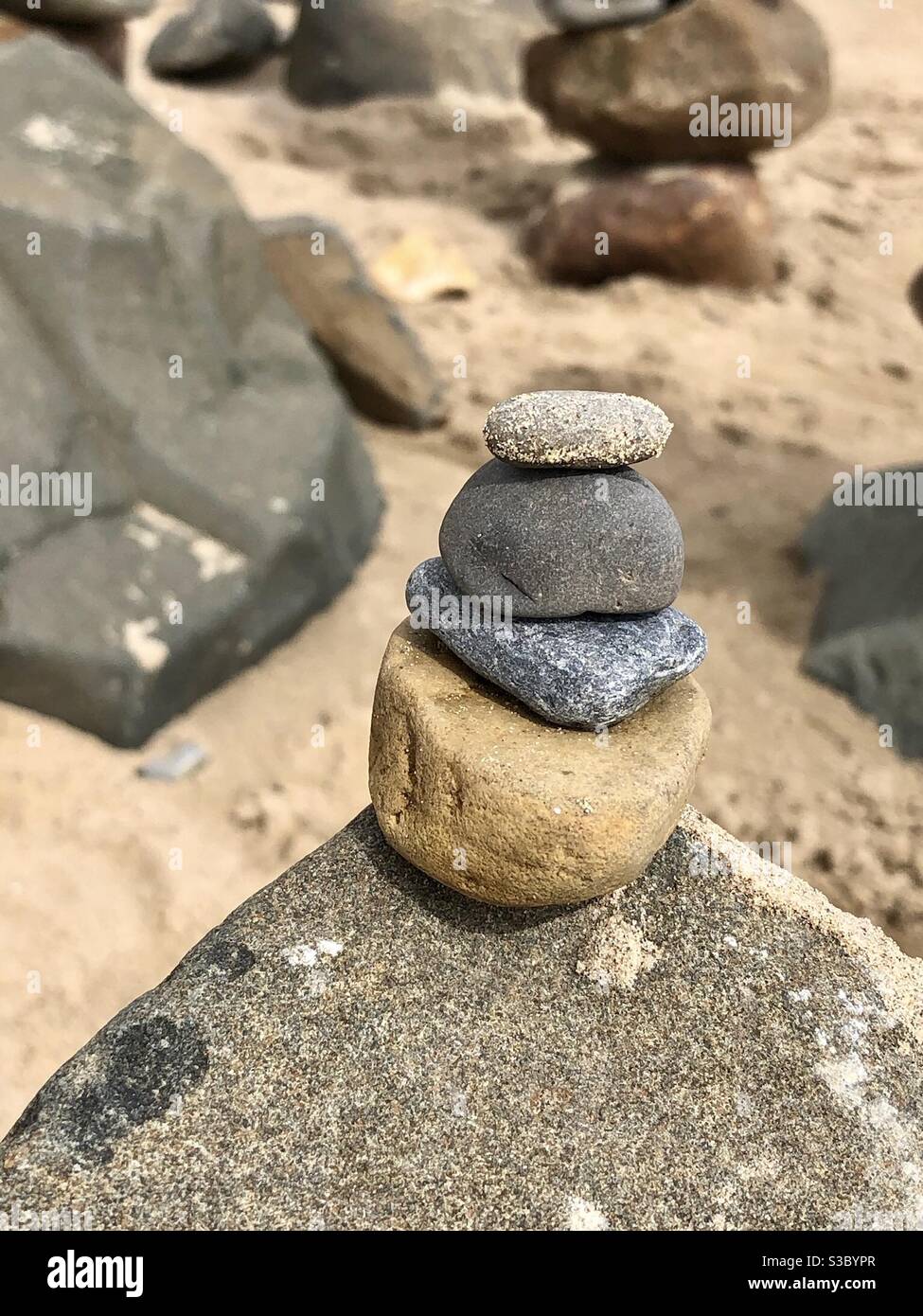 Rock cairn on a sandy beach - Smartphone Captured Stock Image