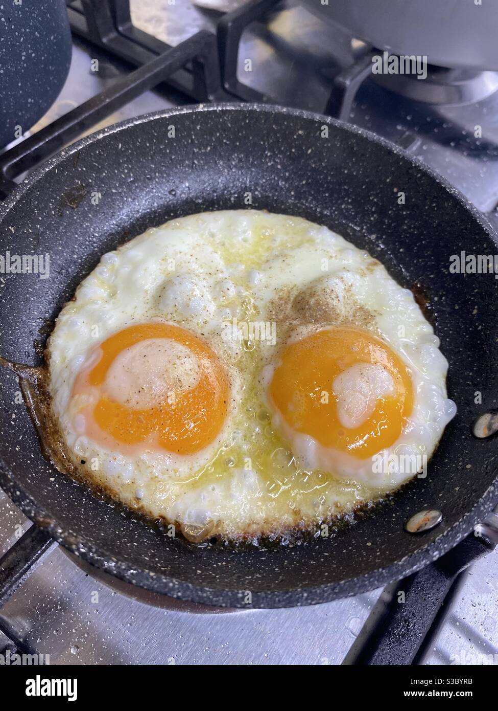 Double Fried Egg in the pan Stock Photo Alamy
