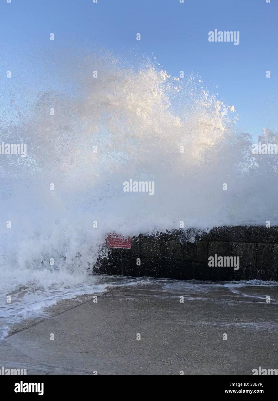 Wave breaking over a sea wall - Smartphone Captured Stock Image