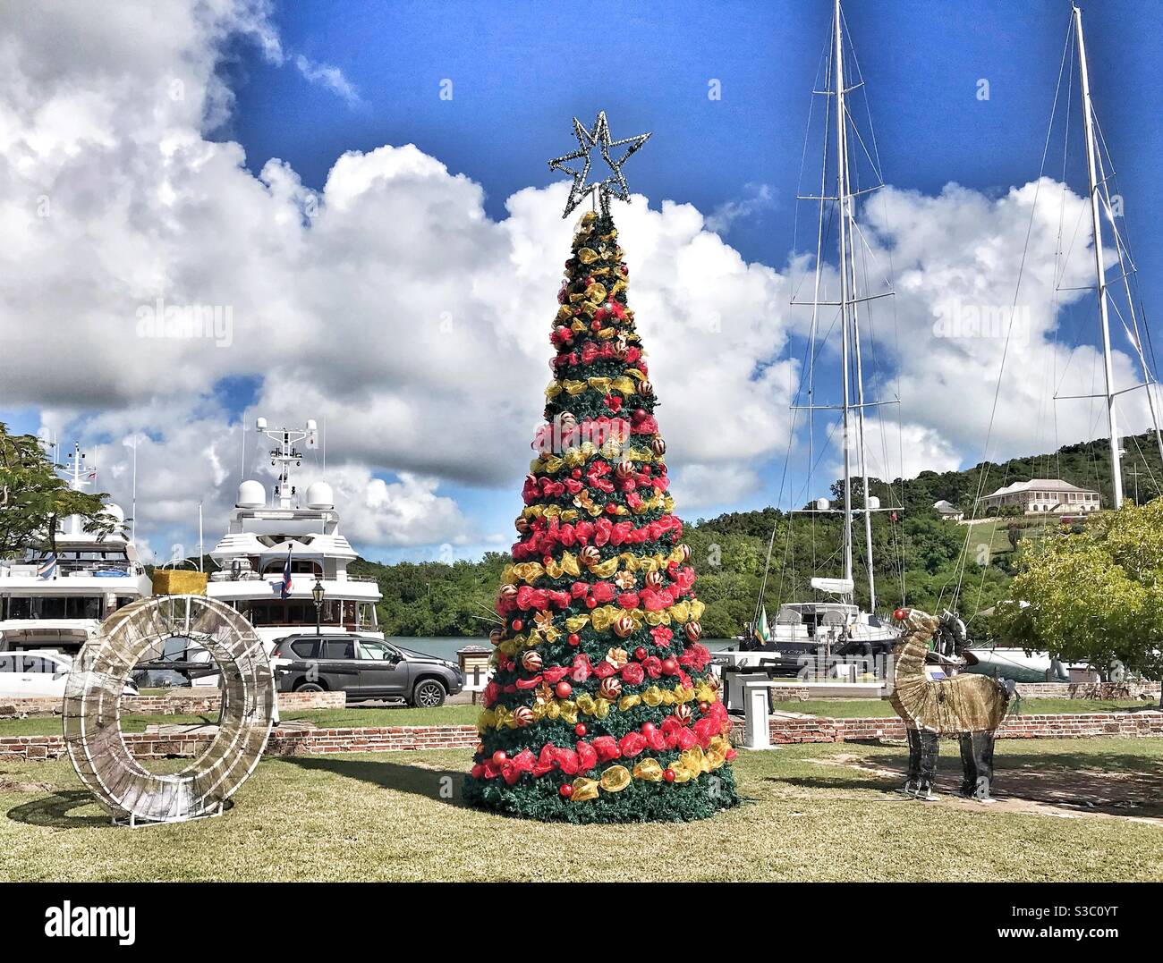 Christmas at Nelsons Dockyard in Antigua, featuring a Christmas Tree with super yachts in the background Stock Photo