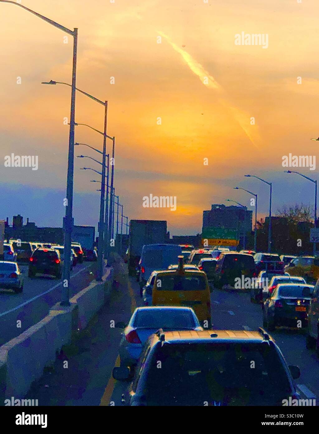 Gorgeous sky over the VanWyk expressway on the way into Manhattan during traffic - Smartphone Captured Stock Image
