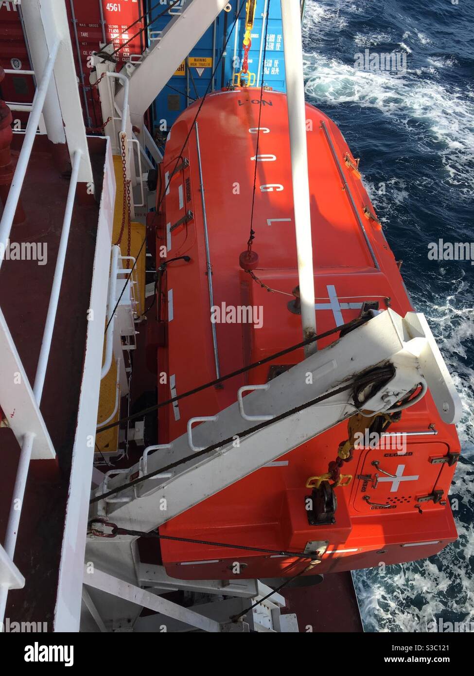 Life boat of the cargo vessel secured on the davit and hanging on the