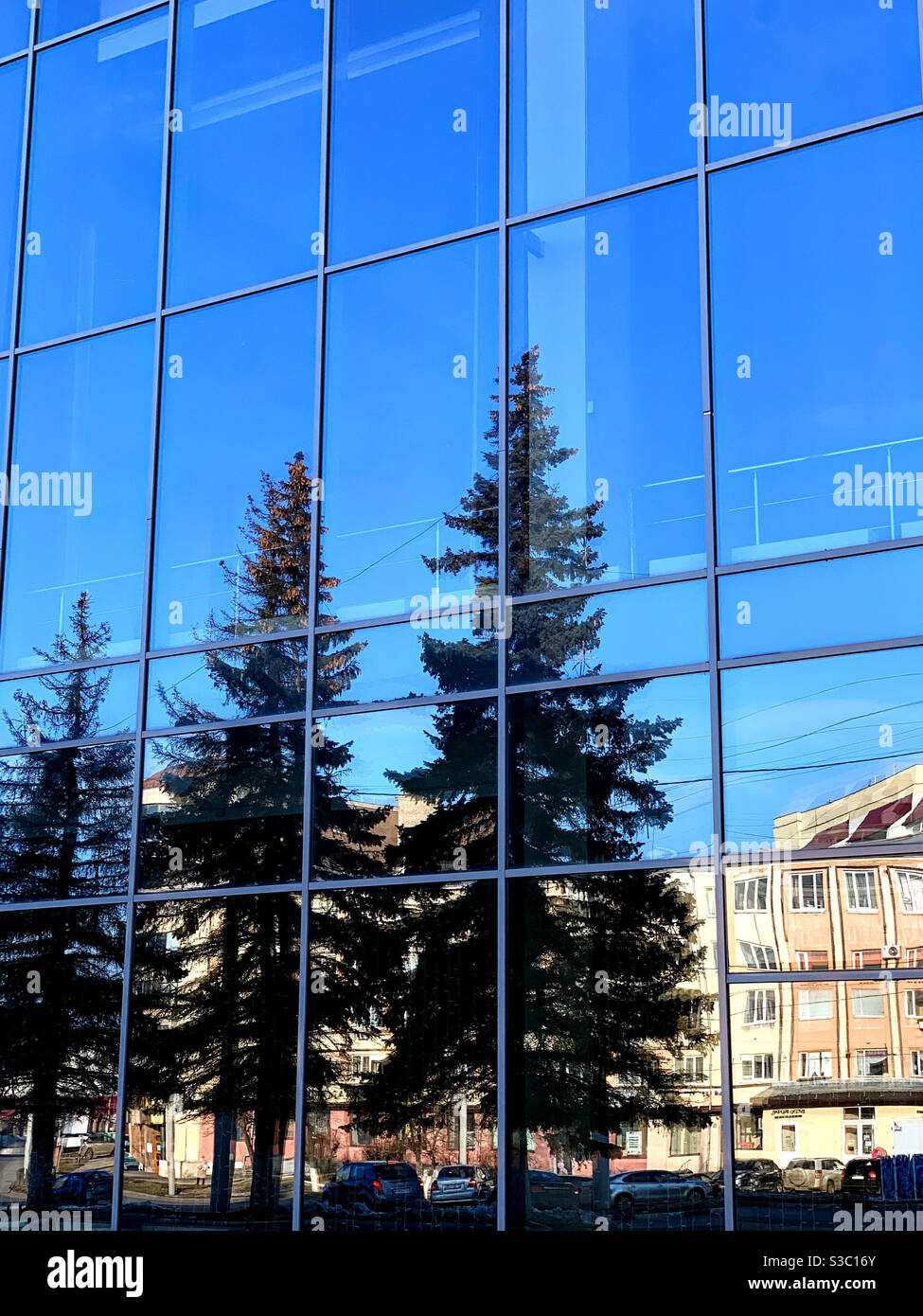 Reflection of the city in a large glass wall of a building - Smartphone Captured Stock Image