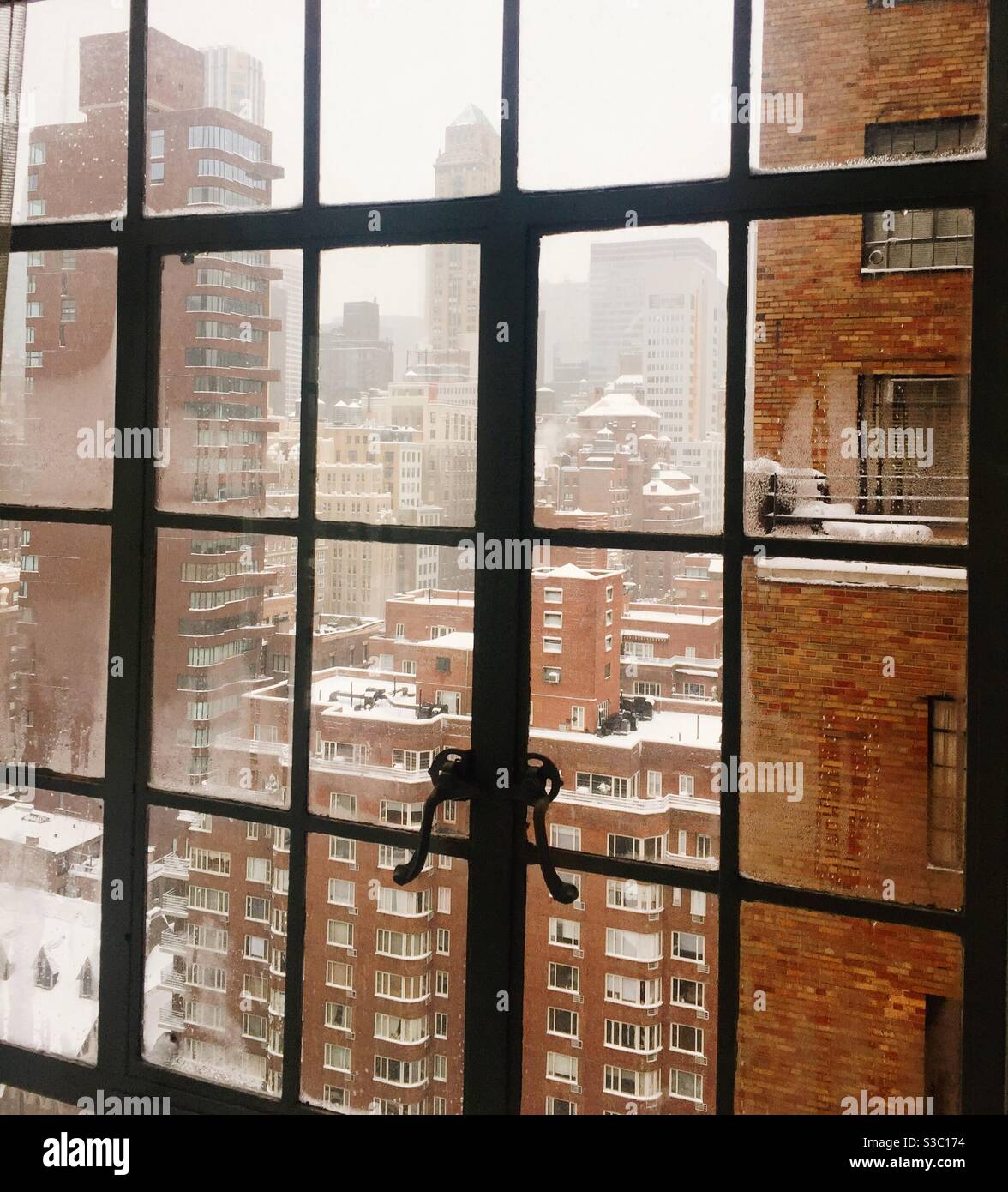 The Murray Hill neighborhood located in Midtown Manhattan is covered in a blanket of snow during a December storm as seen from an apartment window, NYC, USA - Smartphone Captured Stock Image
