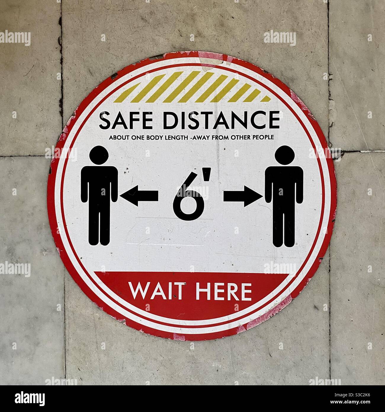 LOS ANGELES, CA, SEP 2020: sign on marble floor showing social distancing rules during coronavirus pandemic restrictions in Downtown Los Angeles - Smartphone Captured Stock Image