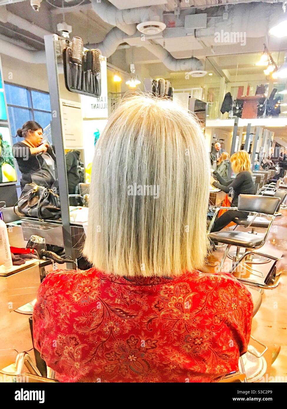 Blonde woman in hair salon - Smartphone Captured Stock Image