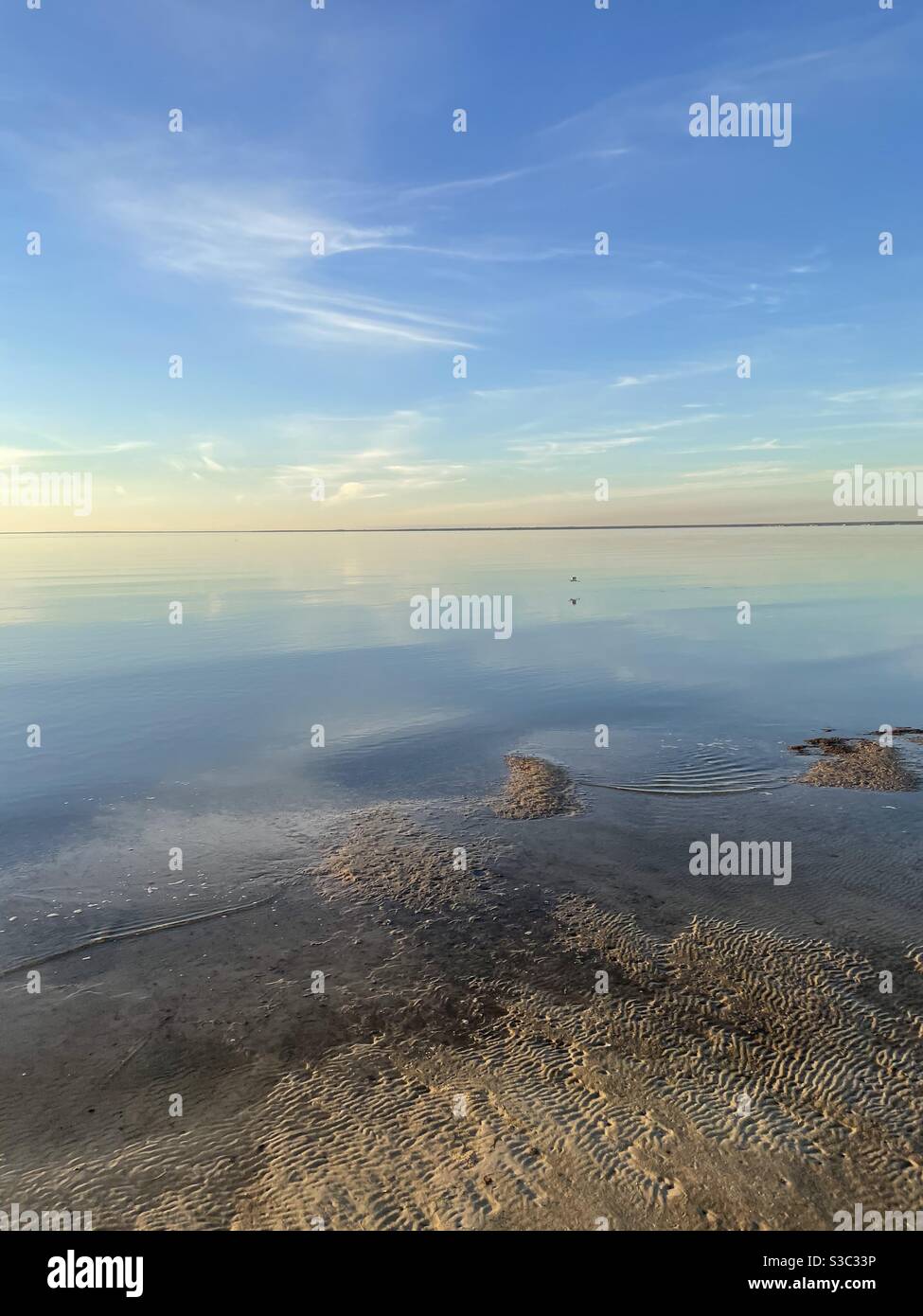 Sunset over the Choctawhatchee bay at low tide with soft pastel skies