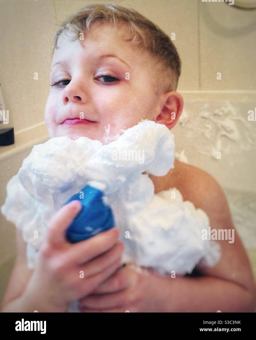 Four year old boy with a beard made from shaving foam. Stock Photo