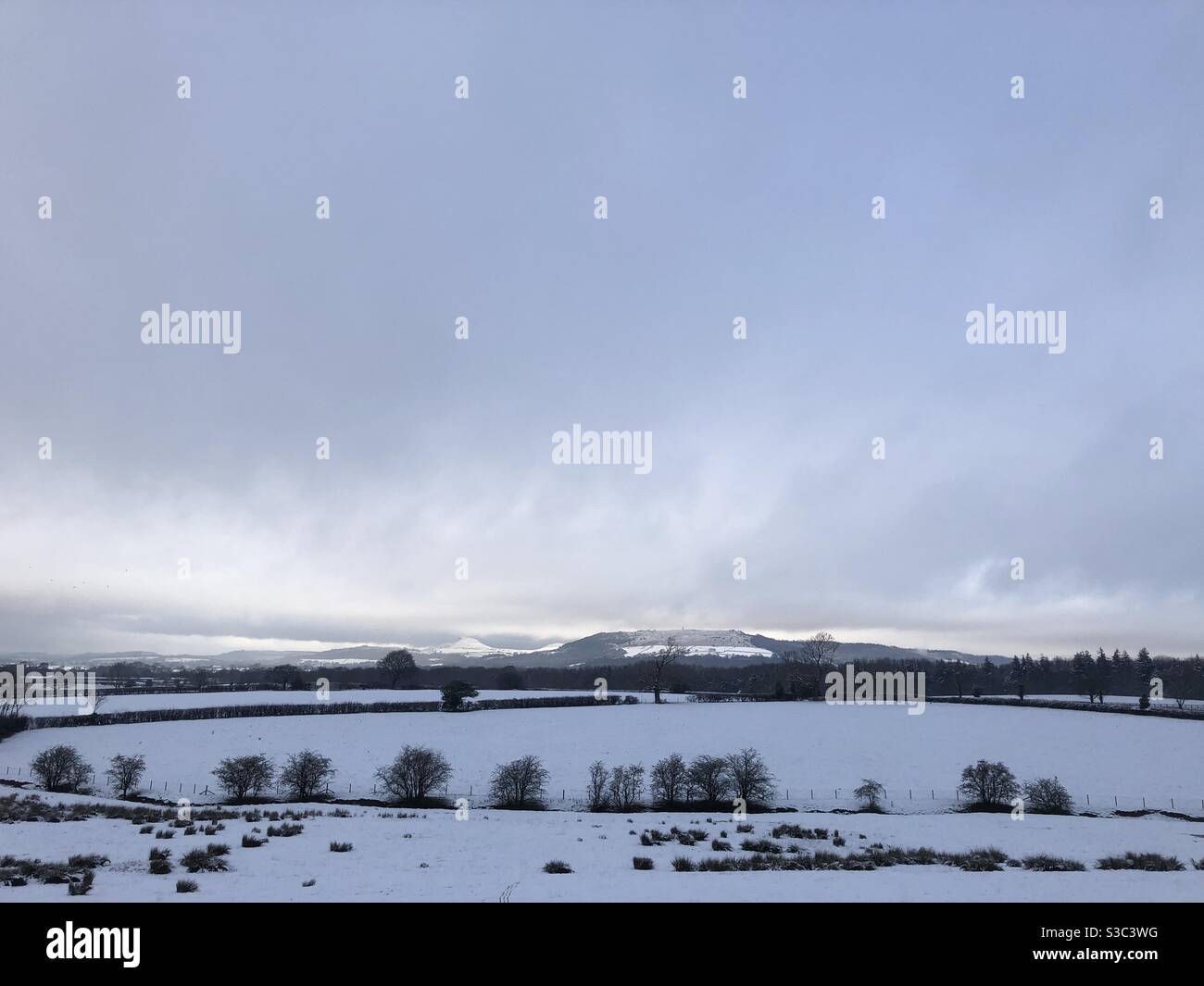 Roseberry Topping and surrounding landscape in a covering of snow. North Yorkshire, England, United Kingdom - Smartphone Captured Stock Image