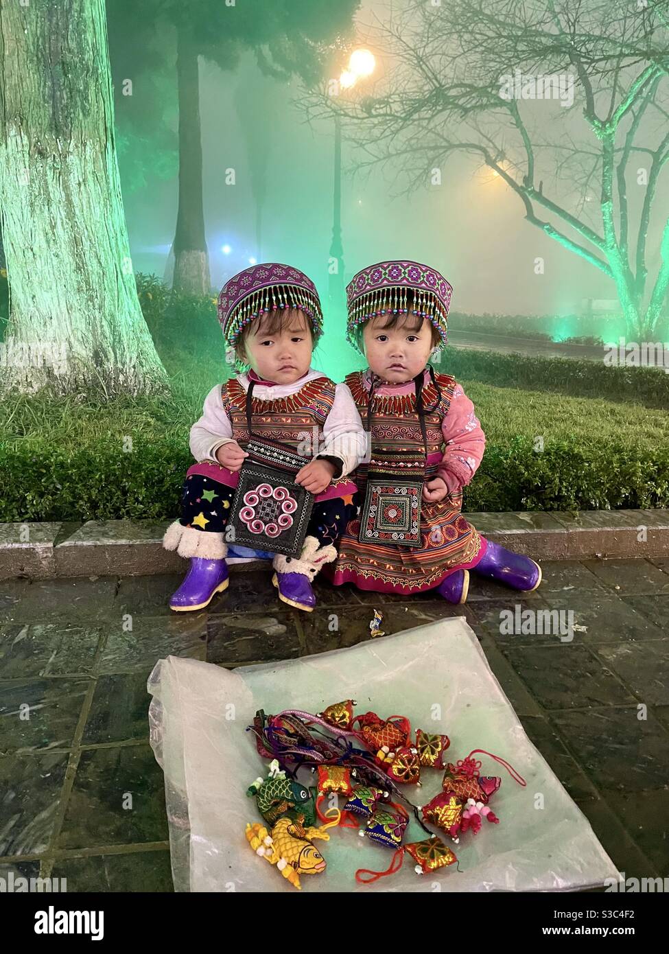 Sa Pa two children map saved electricity under the cold 10 degrees - Smartphone Captured Stock Image