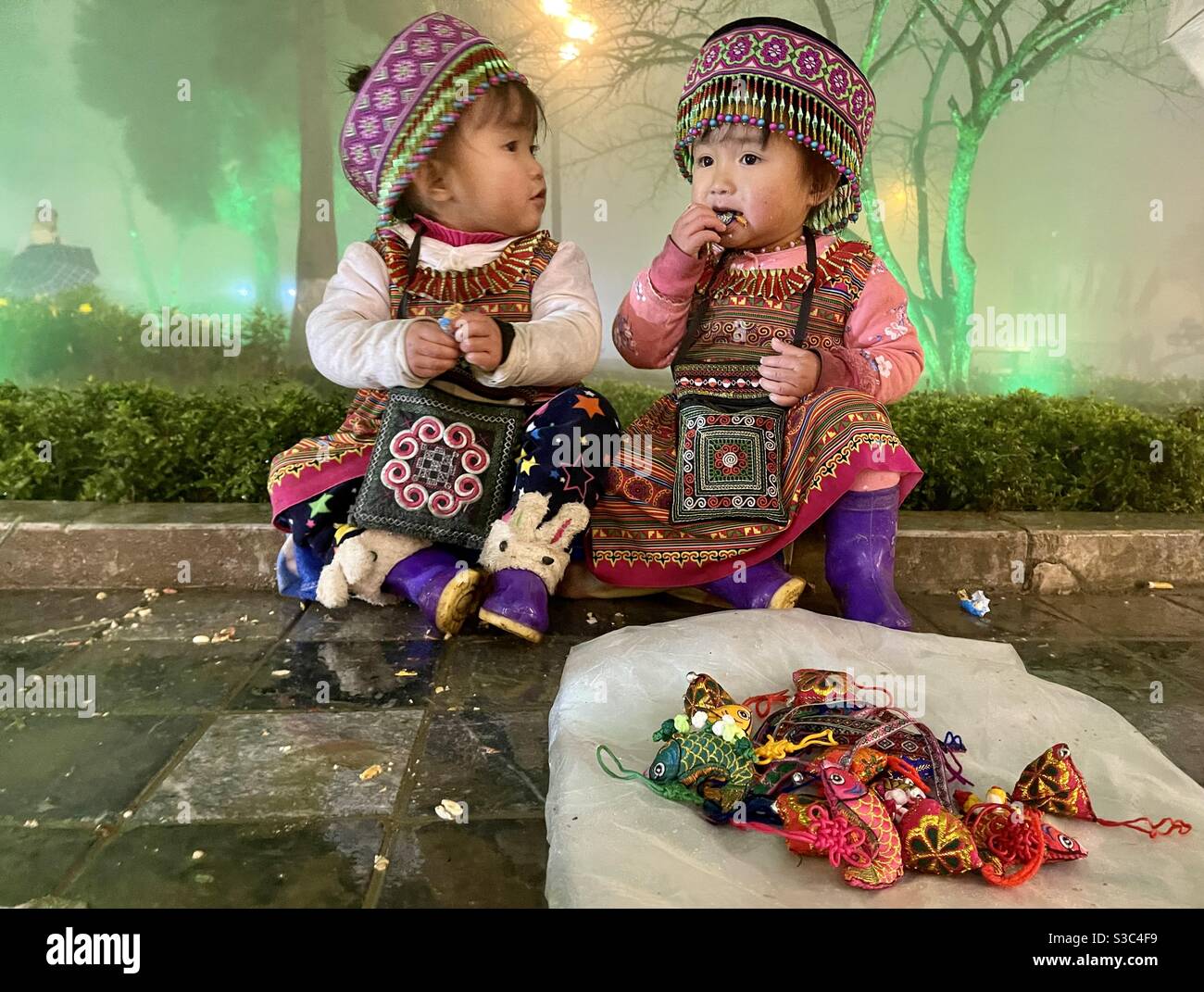 Sa Pa two children map saved electricity under the cold 10 degrees - Smartphone Captured Stock Image