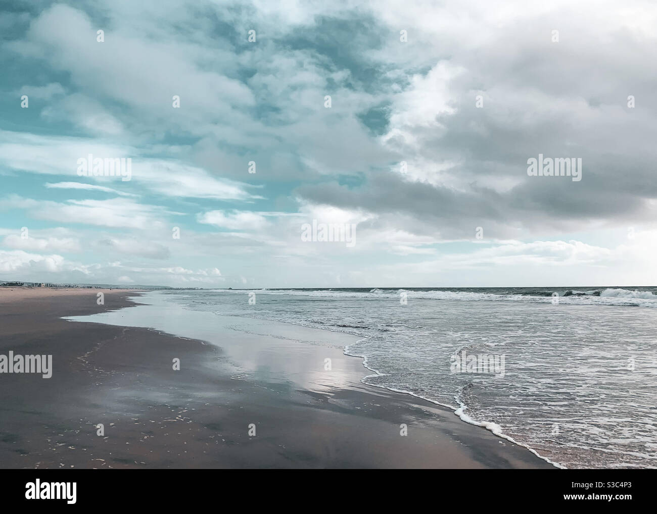 Cloudscape over beach on a windy winter day. - Smartphone Captured Stock Image