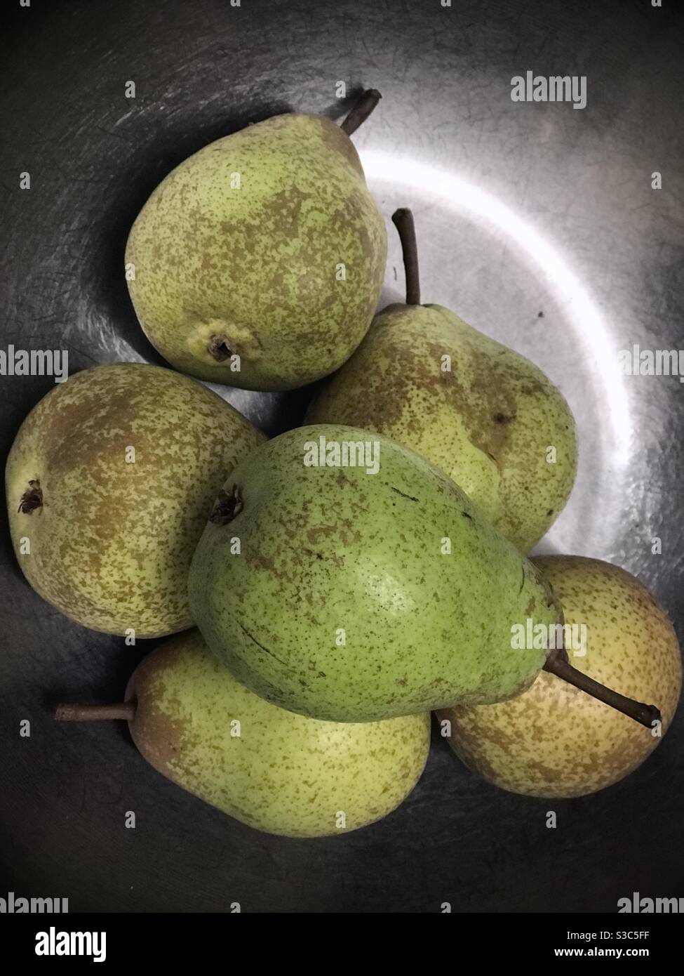 green speckled pears in the crescent light - Smartphone Captured Stock Image