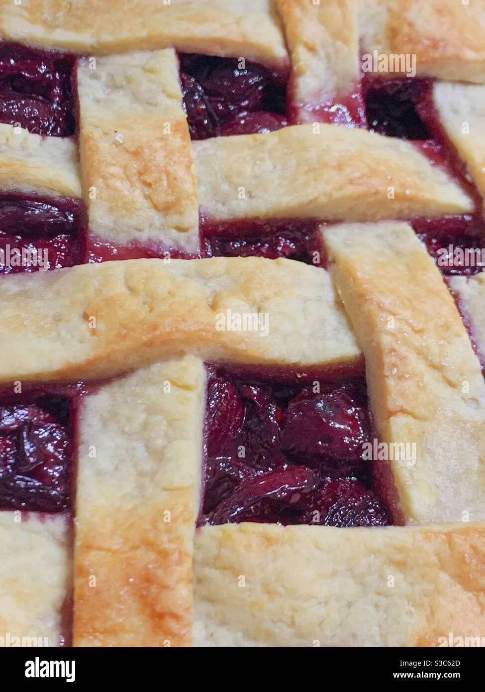 Strips of pastry crosshatching this yummy homemade Cherry pie - Smartphone Captured Stock Image