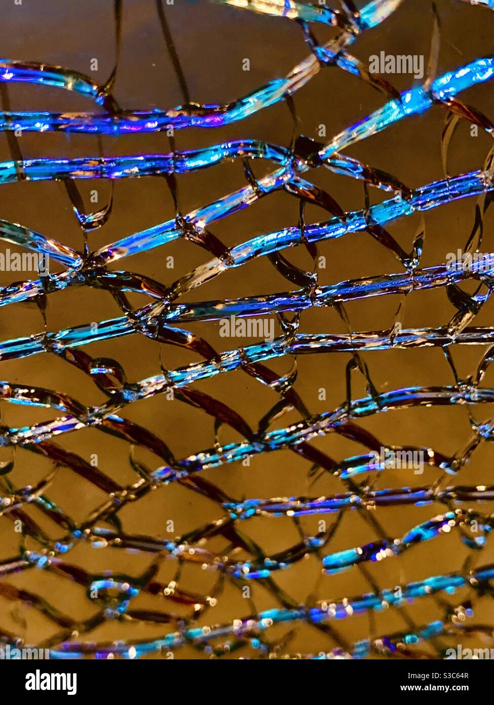 Shattered glass with colourful turquoise refractions Stock Photo