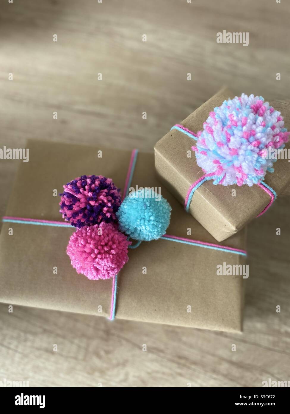 Brown wrapping paper with Pom Poms present Stock Photo