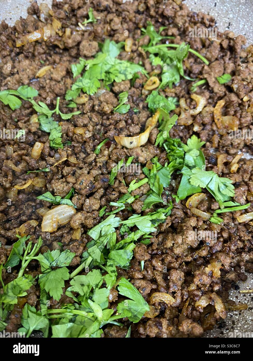 North African spiced beef and chopped parsley Stock Photo