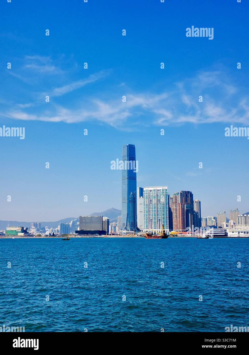 A view of the ICC tower and Victoria harbour in Hong Kong. - Smartphone Captured Stock Image