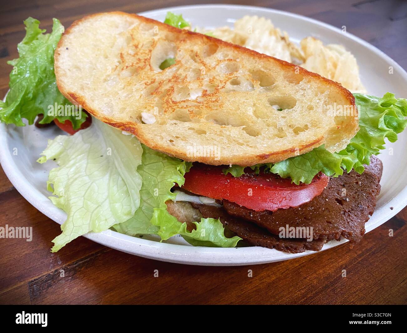 Vegan blt and chips. Stock Photo