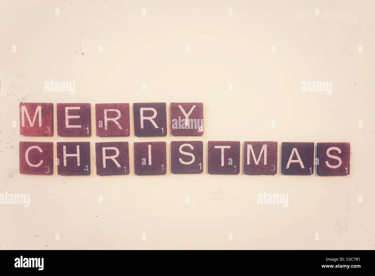 Red wooden tiles spelling out Merry Christmas. - Smartphone Captured Stock Image