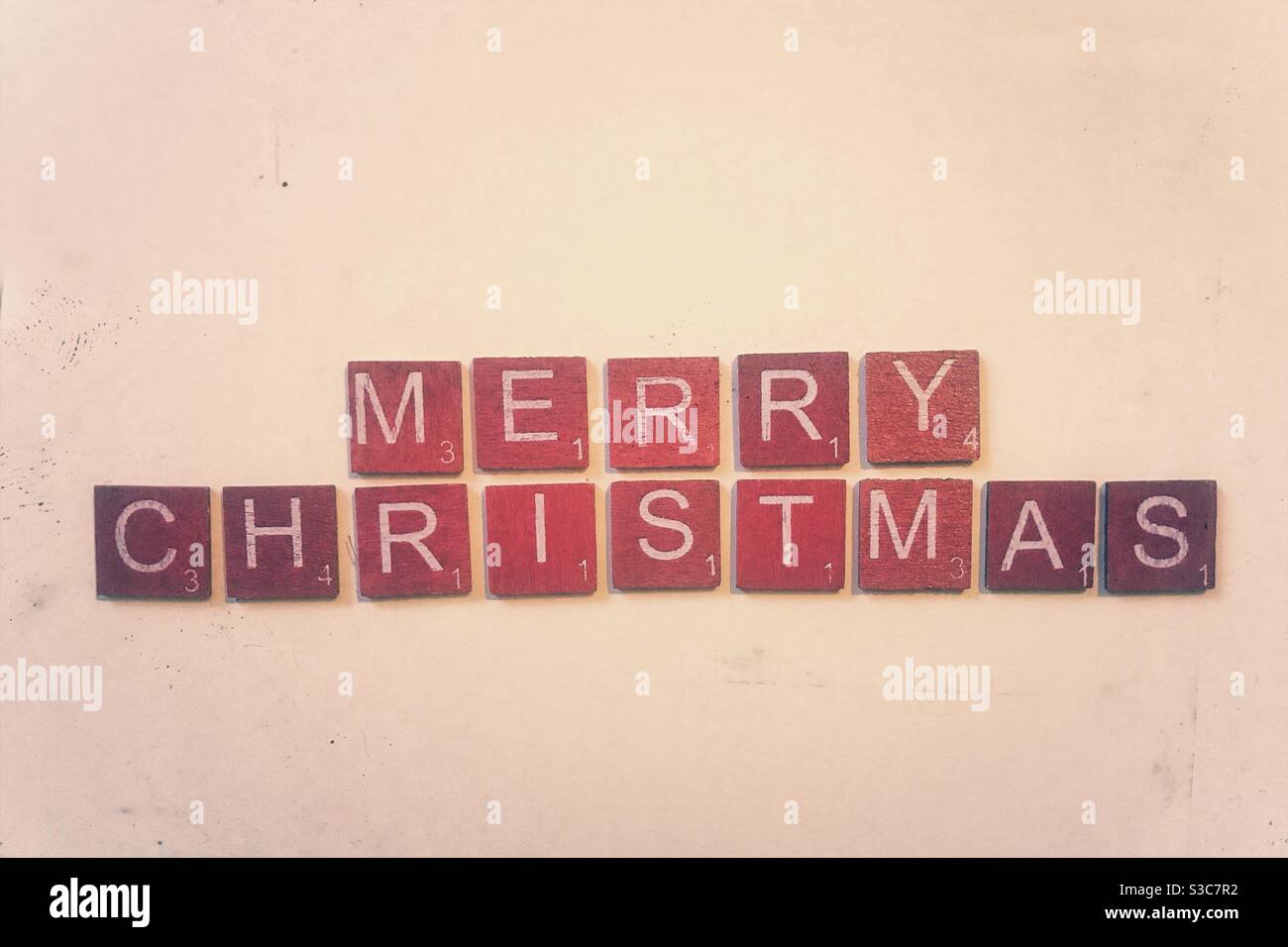 Red wooden tiles spelling out Merry Christmas. - Smartphone Captured Stock Image