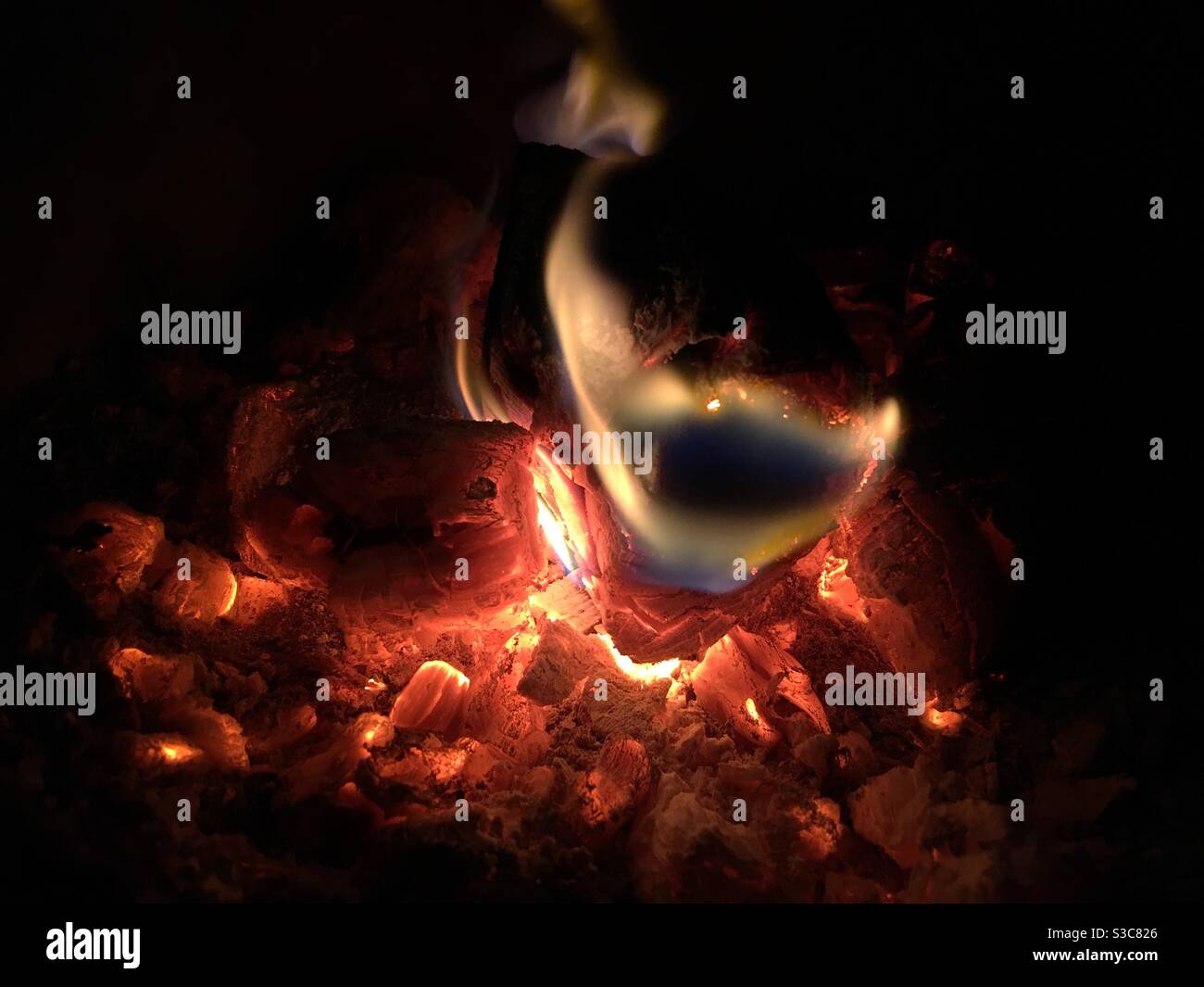 Red hot embers and flames in a fire - Smartphone Captured Stock Image