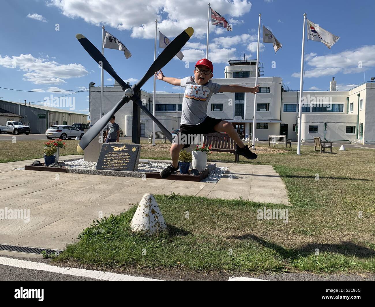 Boy jumping like a propeller at Brighton City airport. Stock Photo