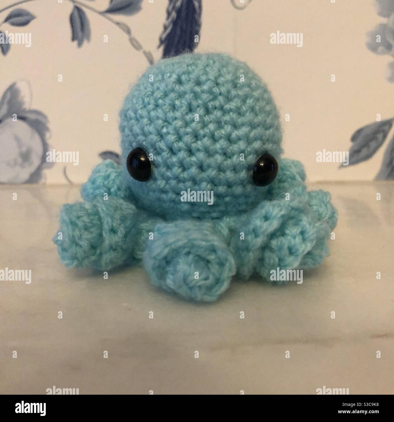 Teal coloured crochet octopus toy Stock Photo