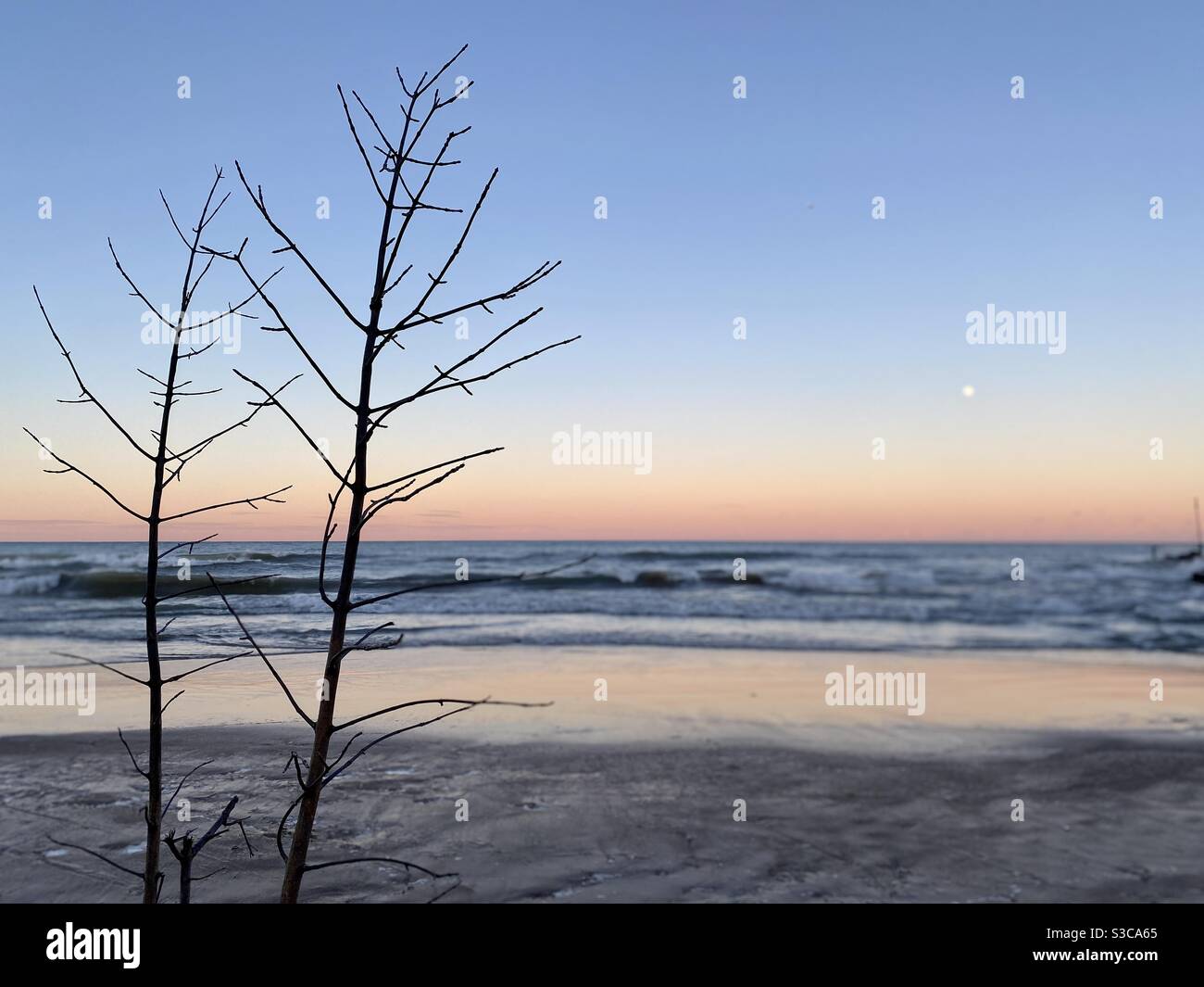Lake Michigan (Illinois shore) at sunset on a winter day with a full moon rising - Smartphone Captured Stock Image