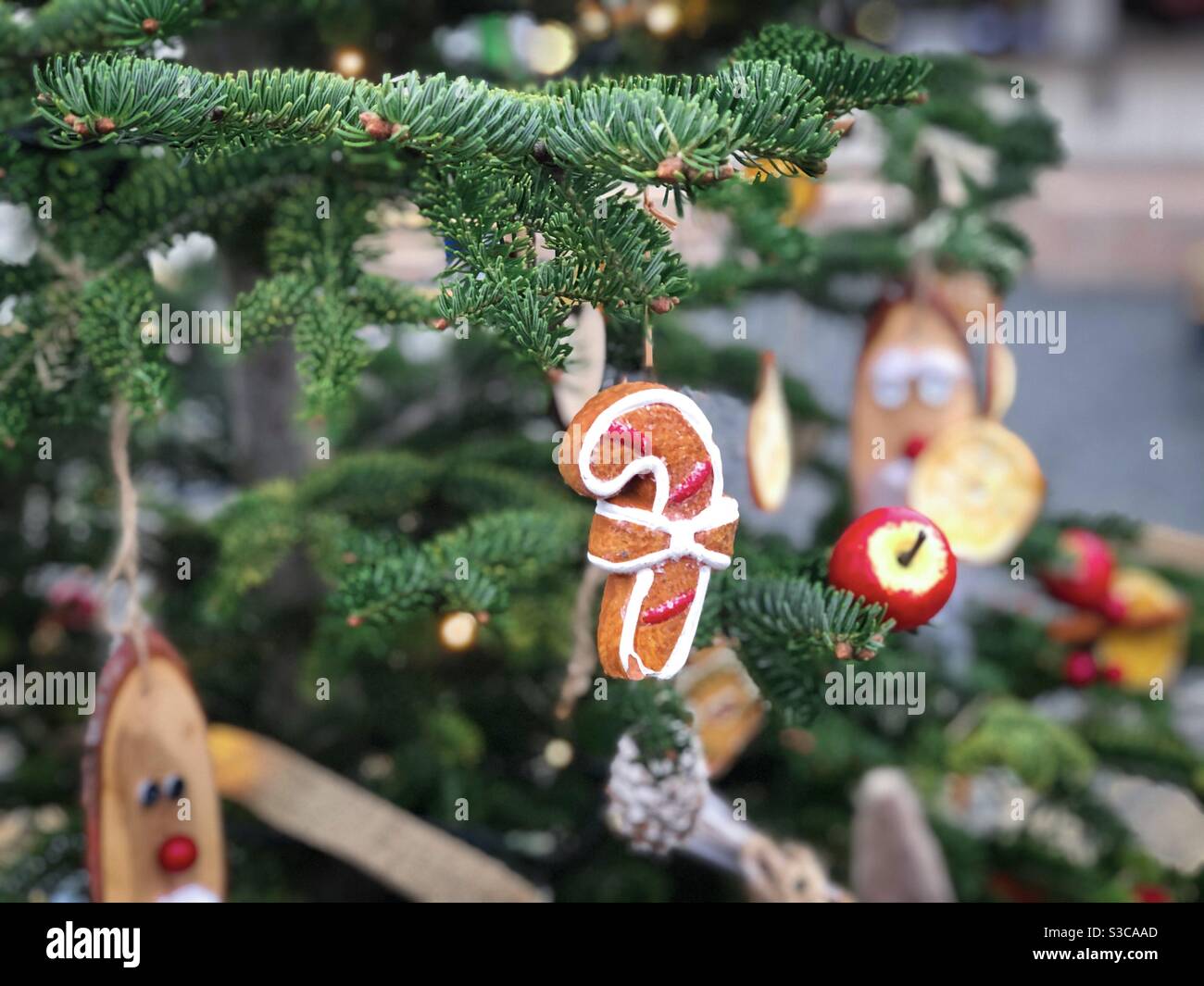 Candy cane globe made of wood hanging in the Christmas tree - Smartphone Captured Stock Image