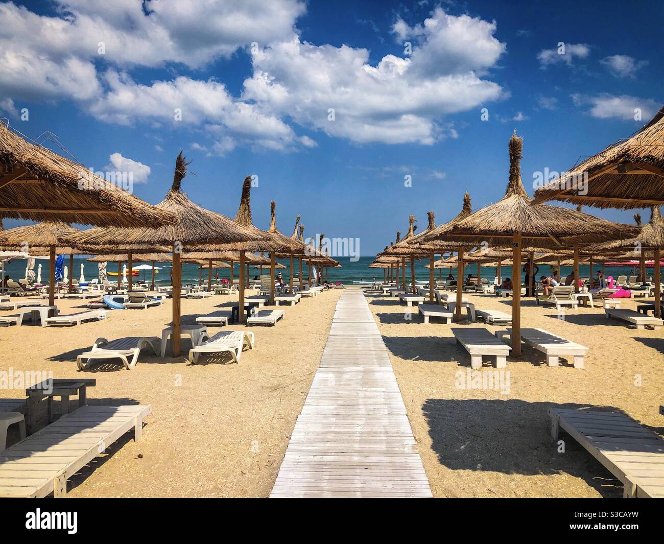 Empty beach with thatched roofs umbrellas - Smartphone Captured Stock Image