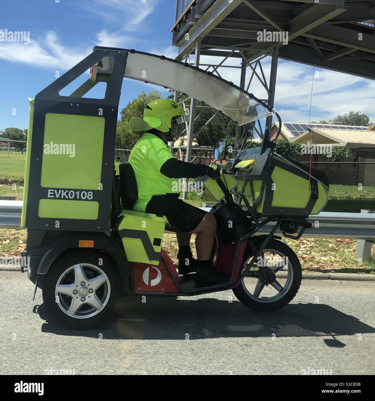Australia Post worker on an ebike and cart Stock Photo Alamy