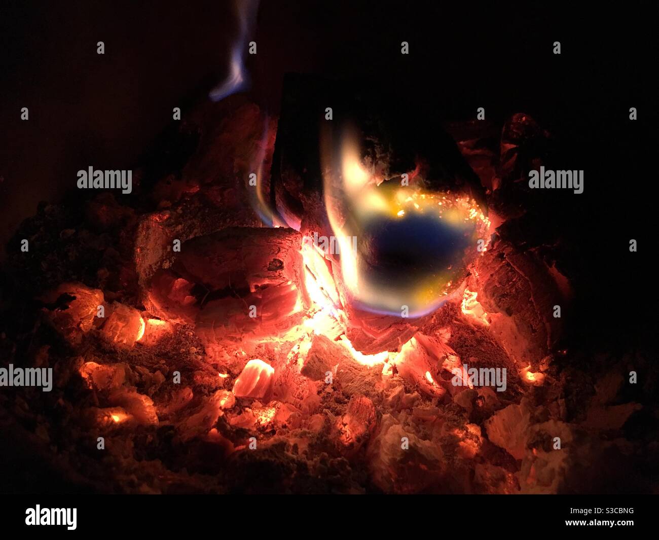 Burning embers and flames in hot fire - Smartphone Captured Stock Image