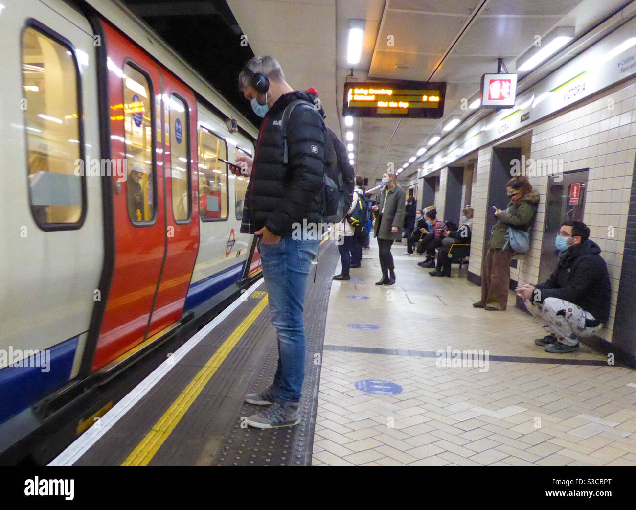 LONDON UNDERGROUND PASSENGERS WEARING FACE MASKS, ON THE PLATFORM