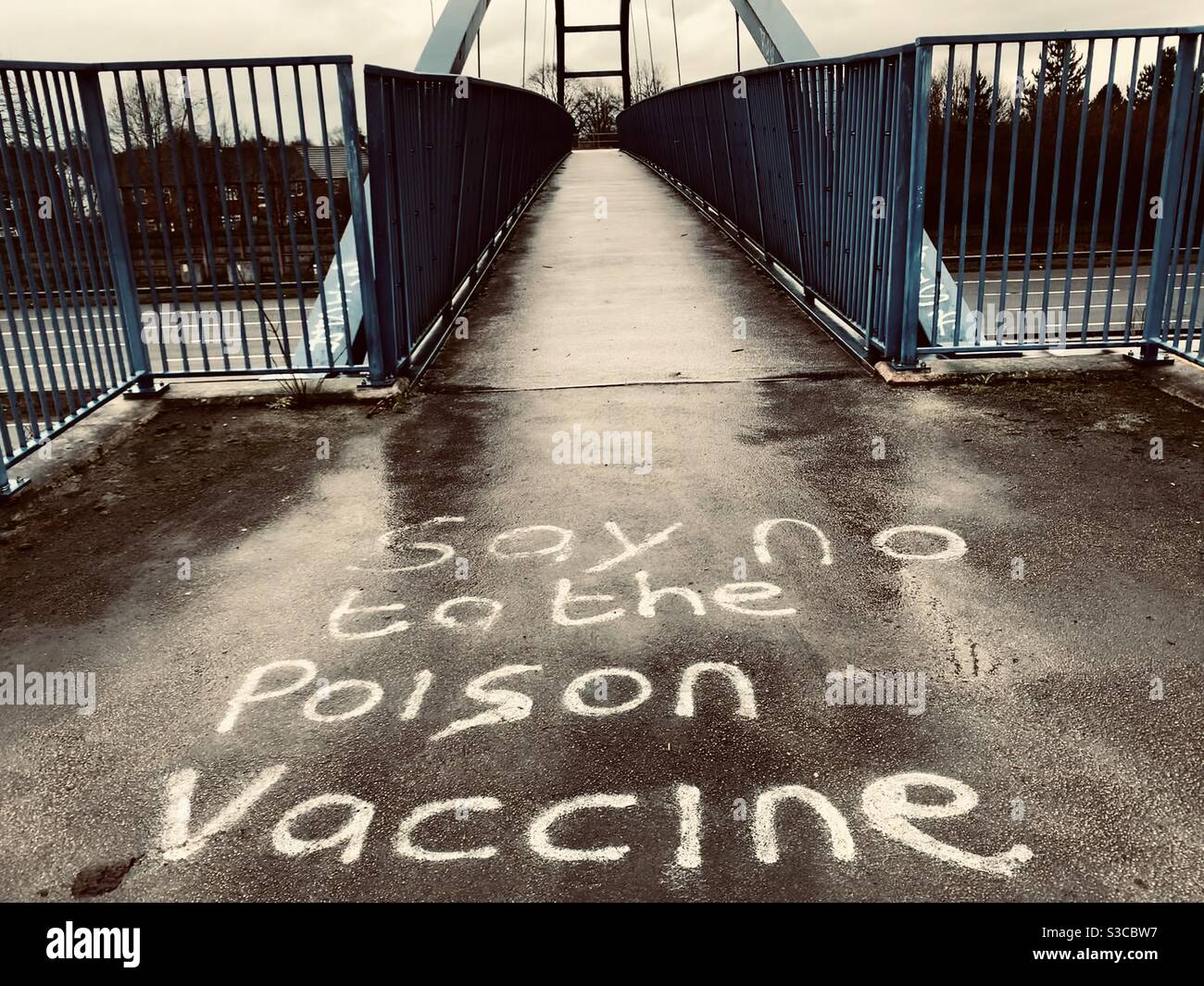 Graffiti on a manchester motorway bridge about covid 19 being a hoax Stock Photo