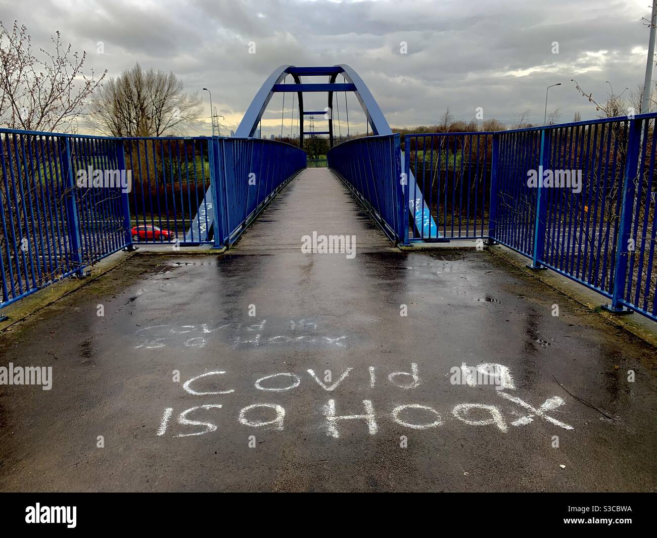 Covid hoax spray paint graffiti on a Manchester motorway footbridge Stock Photo
