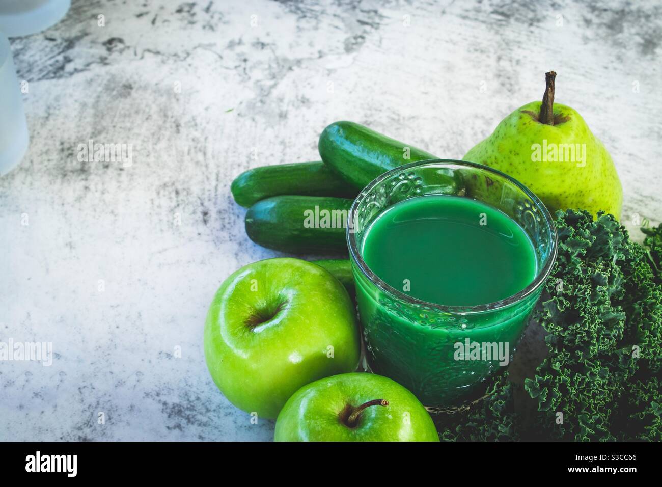 Green juice with pears cucumber apples and kale Stock Photo Alamy