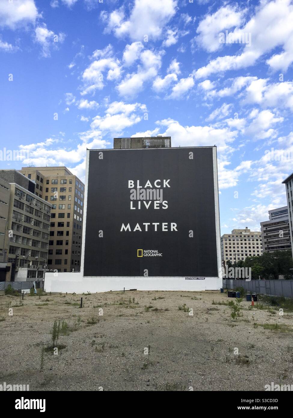 A Black Lives Matter sign covers the side of a building in Washington DC. - Smartphone Captured Stock Image