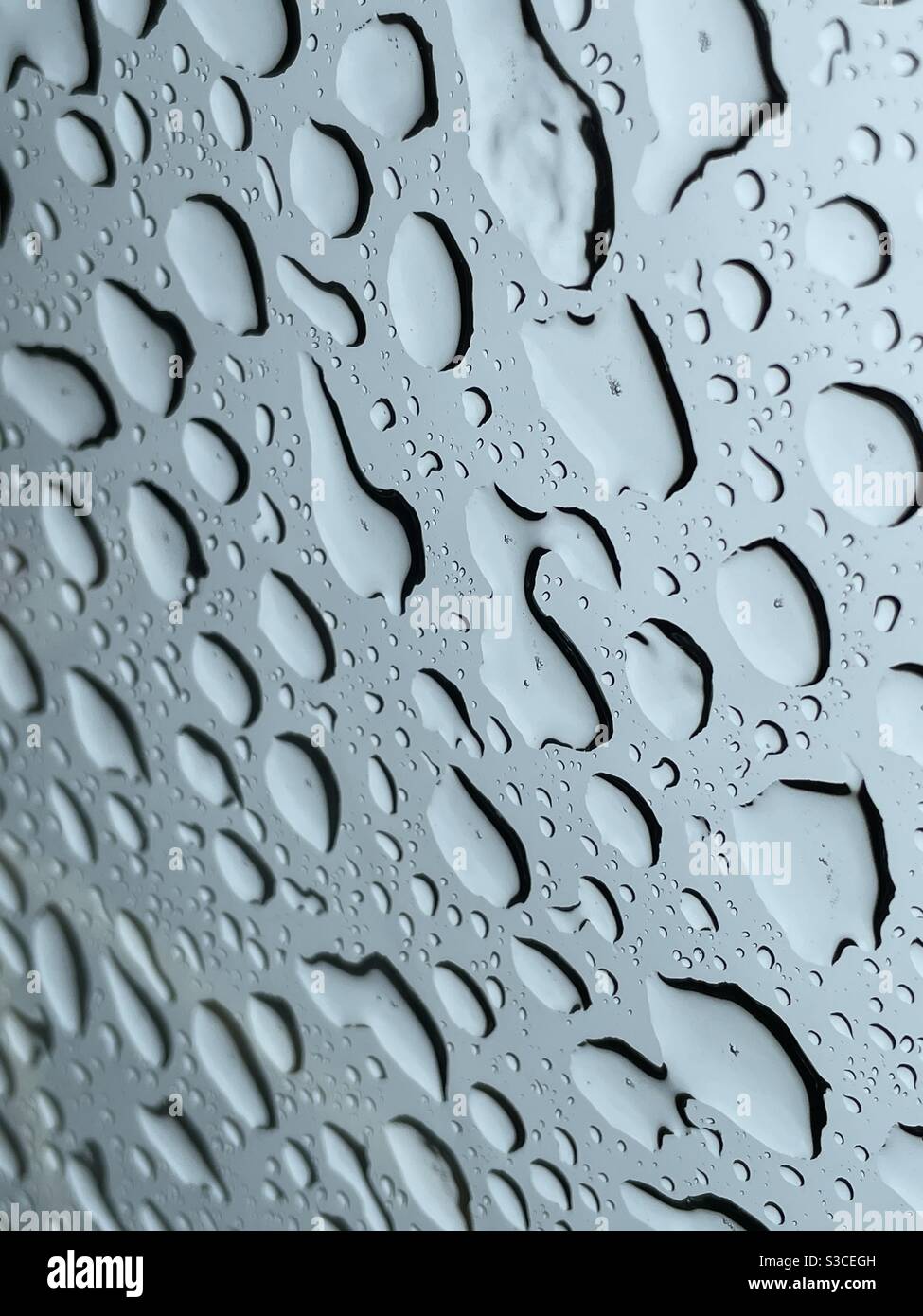 Raindrops on a car skylight - Smartphone Captured Stock Image