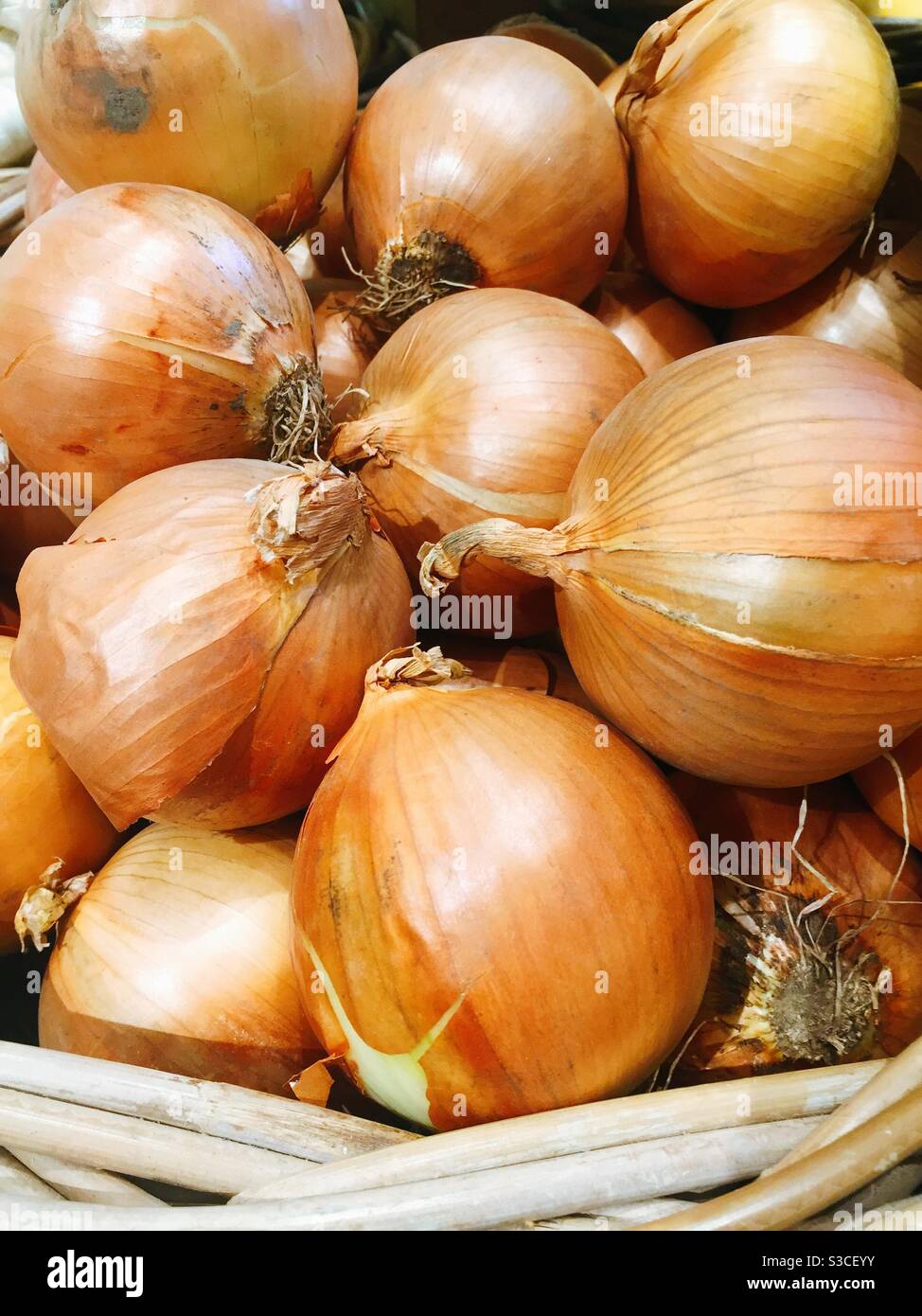 Close up of a basket of raw fresh onions - Smartphone Captured Stock Image