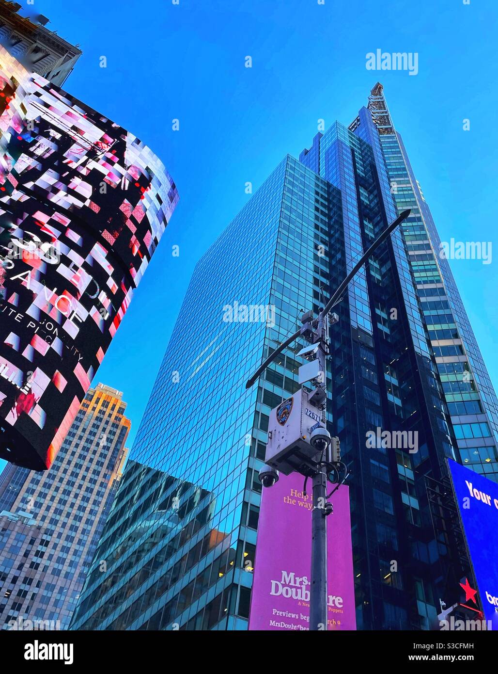 With the flashing, fast-moving neon lights dazzling the city street scene, who even notices the police cameras in Times Square , New York City, USA? - Smartphone Captured Stock Image