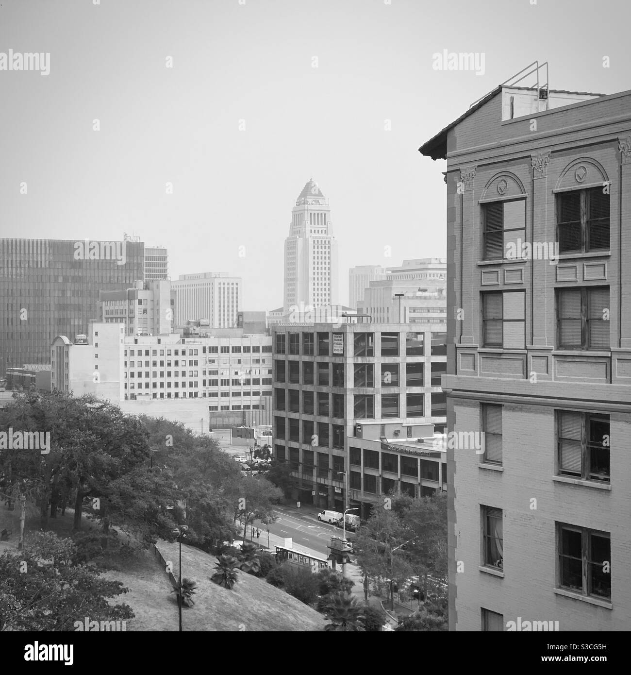 LOS ANGELES, CA, SEP 2020: City Hall seen from near apartment buildings at Bunker Hill in Downtown on a hazy day, black and white - Smartphone Captured Stock Image